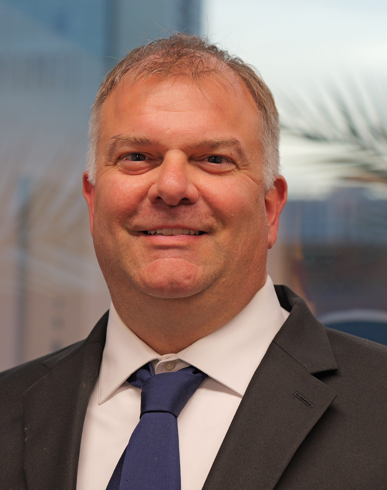 Phil Weinstein, founder and lead safety consultant at Weinstein Safety Consulting, smiling in a professional suit, emphasizing expertise in workplace safety and health training.